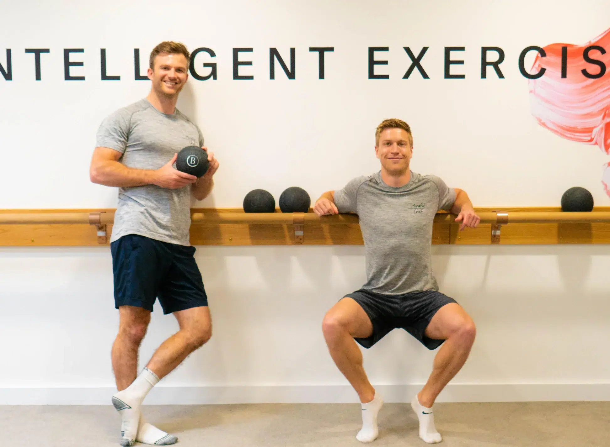 Two male founders of Mindful Chef stand against a Barre in a Barrecore studio