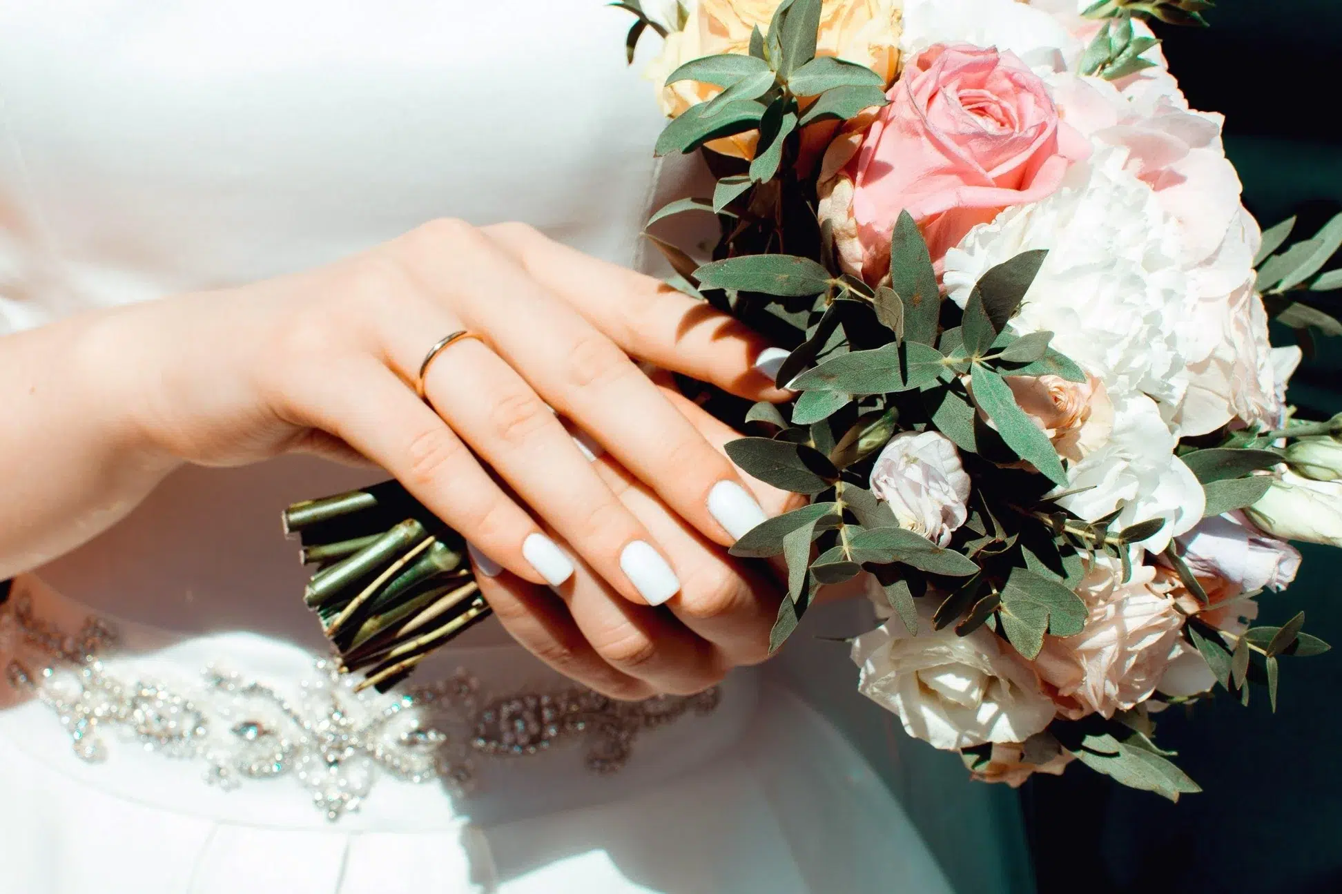 An an image of a brides hands holding a wedding bouquet
